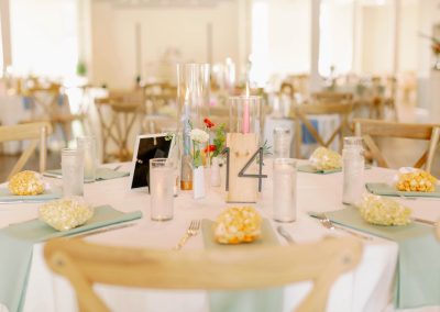 Round table with mint napkins, popcorn favors and a wooden table-14 marker
